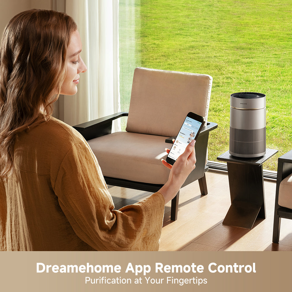 White air purifier on a table while a person controls it on a phone