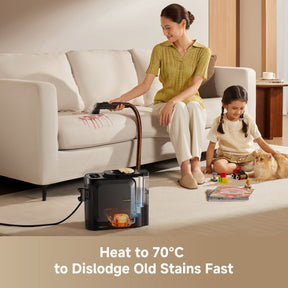 Steam spot cleaner steaming a sofa seat cushion in a living room setting