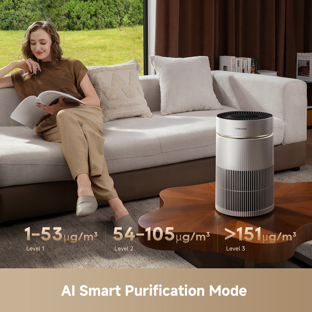 White air purifier standing on the floor beside a sofa in a living room
