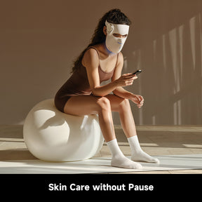 LED skincare mask on face for continuous use while holding a phone