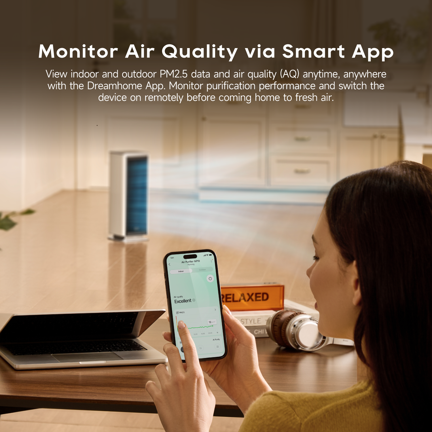 White air purifier fan monitored via smartphone app showing air quality